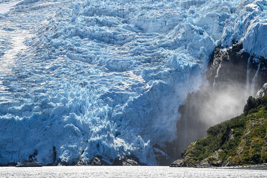 Blue glacier face meeting the sea in Prince William Sound, Alaska