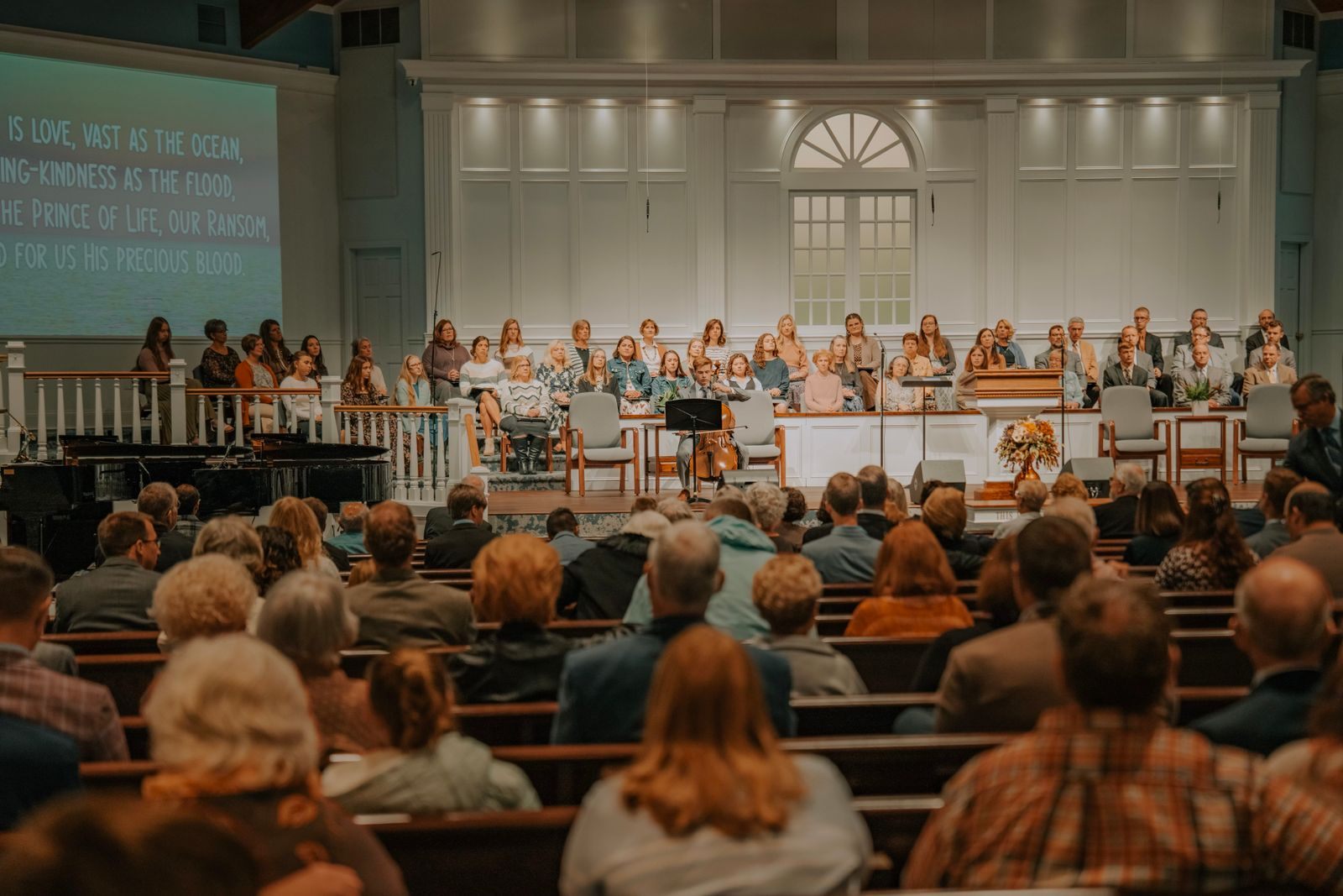 Congregation seated in a church auditorium during a service with a choir
